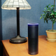 FILE - This July 29, 2015 file photo made in New York shows Amazon's Echo, a digital assistant that continually listens for commands such as for a song, a sports score or the weather. The company says Echo transmits nothing to Amazon’s data centers until you first say “Alexa” or press a button. A blue light also comes on to let you know it’s active. (AP Photo/Mark Lennihan, File)